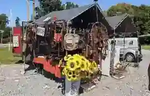 Buffalo Leather Belts outdoor market stand with handmade leather goods displayed under a canopy